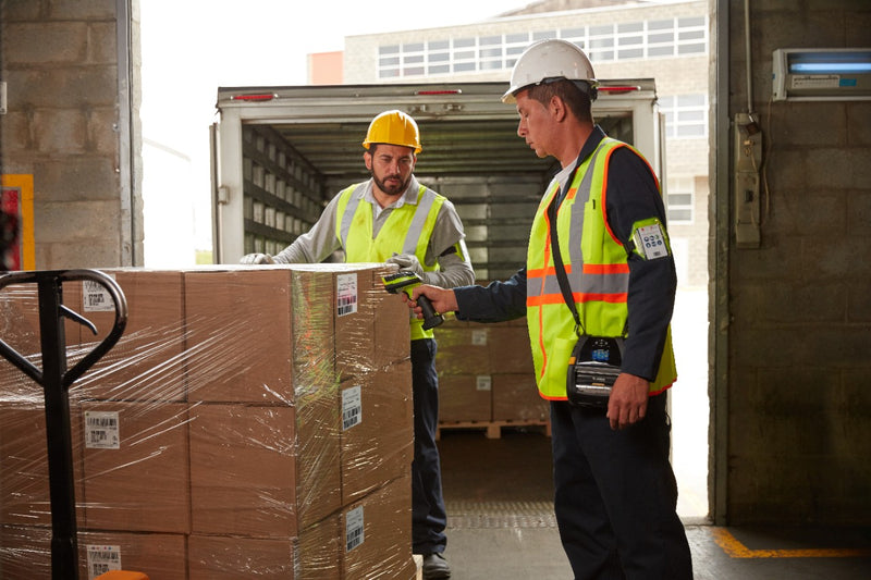 Men scanning labels on a pallet